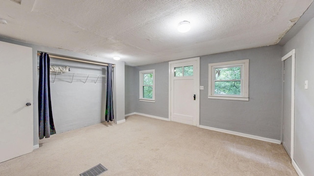 3672 Snelling Ave N, Arden Hills, MN 55112 - unfurnished bedroom featuring a textured ceiling, carpet flooring, a closet, and multiple windows