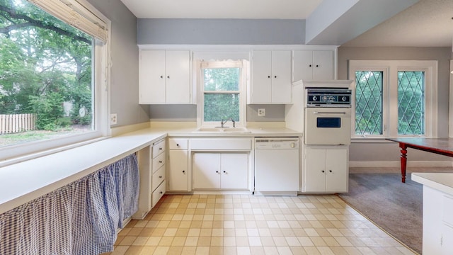3672 Snelling Ave N, Arden Hills, MN 55112 - kitchen with white appliances, healthy amount of natural light, and light countertops