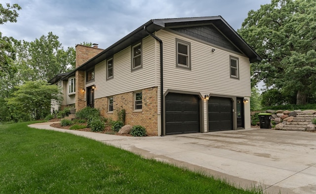 25 Conway Ct SE, Rochester Twp, MN 55904 - view of side of property with an attached garage, a chimney, driveway, and a lawn