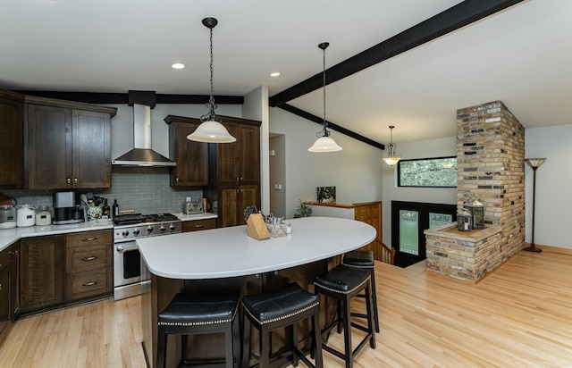 25 Conway Ct SE, Rochester Twp, MN 55904 - kitchen featuring gas range, wall chimney exhaust hood, light wood-type flooring, backsplash, and light countertops