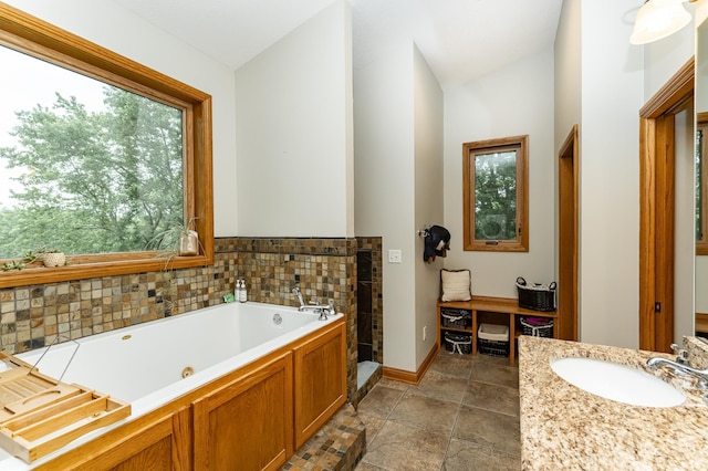 25 Conway Ct SE, Rochester Twp, MN 55904 - bathroom with healthy amount of natural light, a jetted tub, vanity, and vaulted ceiling