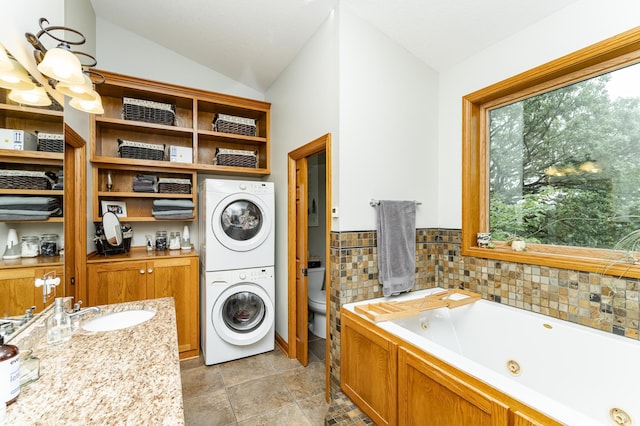 25 Conway Ct SE, Rochester Twp, MN 55904 - laundry area with stacked washer / drying machine and a sink
