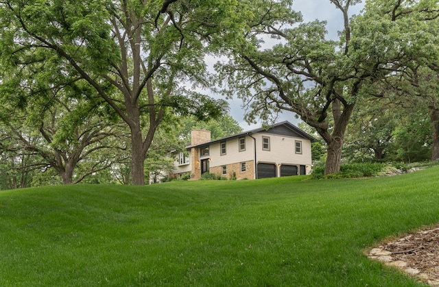 25 Conway Ct SE, Rochester Twp, MN 55904 - view of grassy yard with a garage