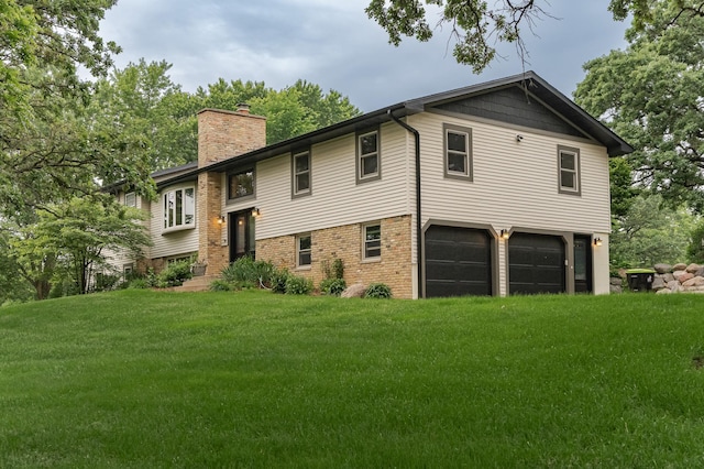 25 Conway Ct SE, Rochester Twp, MN 55904 - view of front facade with a garage, a chimney, a front yard, and brick siding