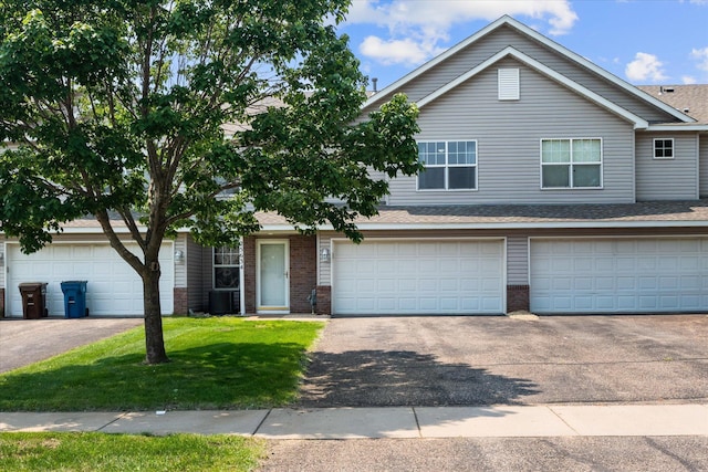 25634 3rd St W, Zimmerman, MN 55398 - view of front of home featuring asphalt driveway, brick siding, and a front yard