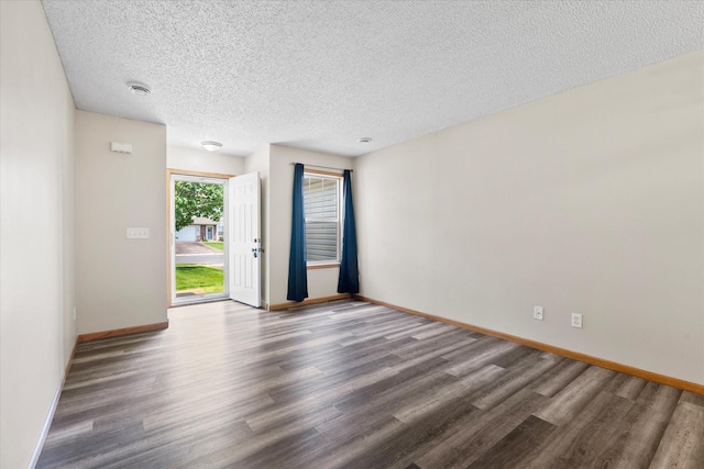 25634 3rd St W, Zimmerman, MN 55398 - spare room featuring wood finished floors, a textured ceiling, and a smoke detector