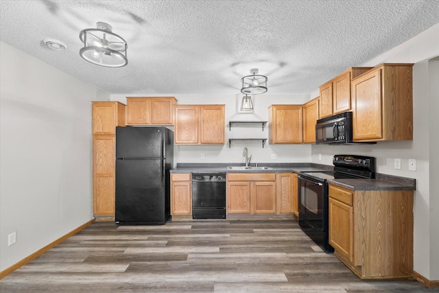 25634 3rd St W, Zimmerman, MN 55398 - kitchen with black appliances, dark countertops, wood finished floors, and a textured ceiling