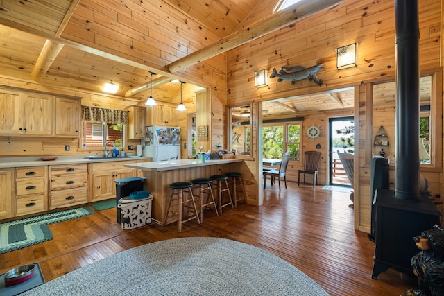 14292 Chippewa Loop, Park Rapids, MN 56470 - kitchen with freestanding refrigerator, wood walls, light brown cabinetry, dark wood-type flooring, and light countertops