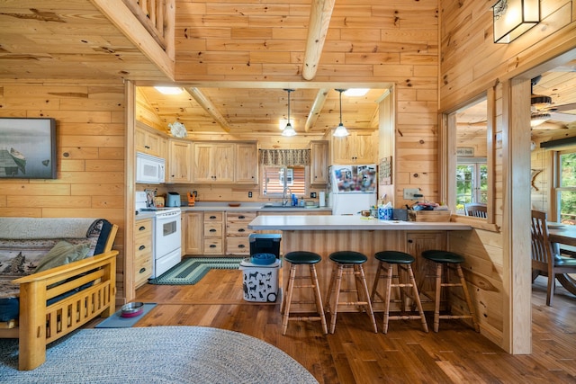 14292 Chippewa Loop, Park Rapids, MN 56470 - kitchen featuring white appliances, wood walls, light brown cabinets, hardwood / wood-style floors, and a peninsula