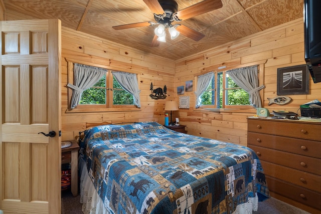 14292 Chippewa Loop, Park Rapids, MN 56470 - bedroom featuring wooden walls, carpet flooring, and ceiling fan