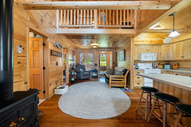 14292 Chippewa Loop, Park Rapids, MN 56470 - living room with wood walls, a wood stove, dark wood-type flooring, and a wood ceiling with exposed beams