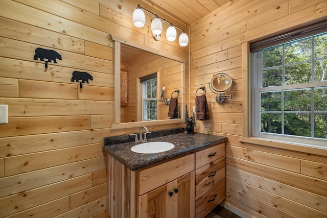 14292 Chippewa Loop, Park Rapids, MN 56470 - bathroom featuring wood walls, vanity, plenty of natural light, and wooden ceiling