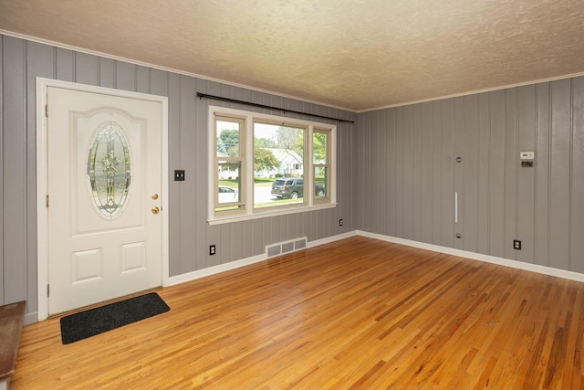 2010 Oakland Ave, Austin, MN 55912 - foyer entrance featuring wood finished floors, crown molding, and a textured ceiling