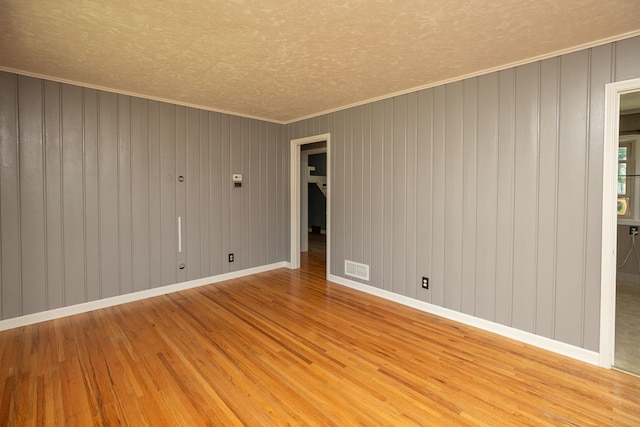 2010 Oakland Ave, Austin, MN 55912 - spare room with wood finished floors, a textured ceiling, and ornamental molding