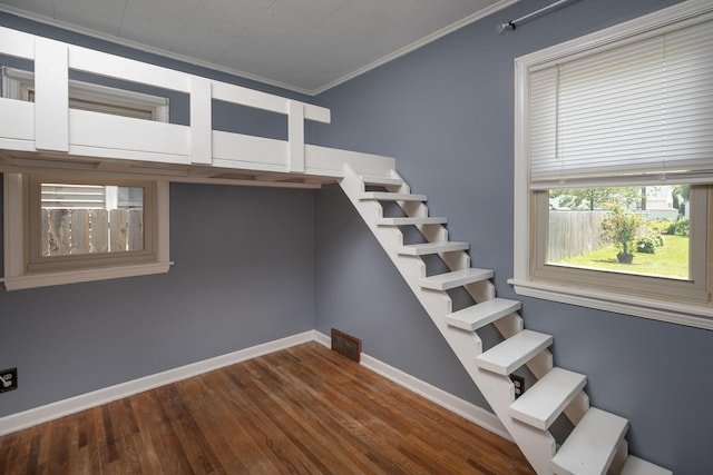 2010 Oakland Ave, Austin, MN 55912 - stairway featuring crown molding and wood finished floors
