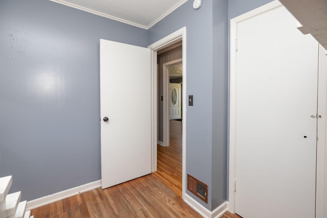 2010 Oakland Ave, Austin, MN 55912 - unfurnished bedroom with wood finished floors, crown molding, and a closet