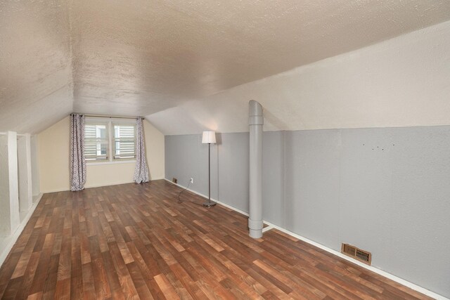 2010 Oakland Ave, Austin, MN 55912 - bonus room with a textured ceiling, wood finished floors, and vaulted ceiling