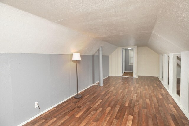 2010 Oakland Ave, Austin, MN 55912 - additional living space featuring a textured ceiling, wood finished floors, and lofted ceiling