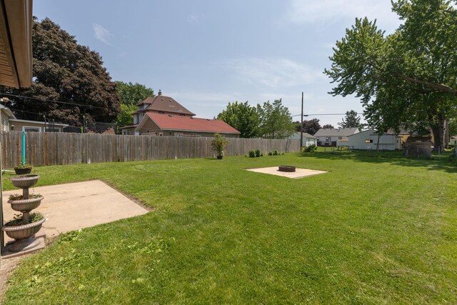 2010 Oakland Ave, Austin, MN 55912 - fenced backyard featuring a patio and an outdoor fire pit