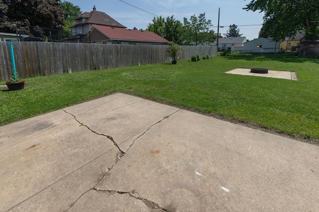 2010 Oakland Ave, Austin, MN 55912 - fenced backyard with a fire pit and a patio area