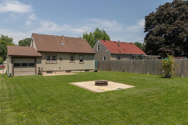 2010 Oakland Ave, Austin, MN 55912 - view of yard with an outdoor fire pit, a patio, and a garage