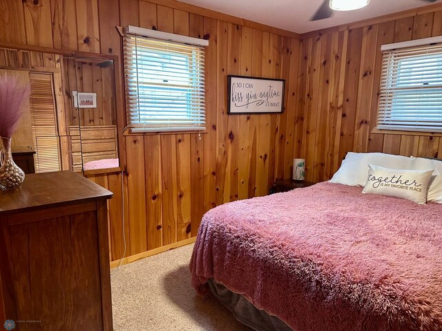 12981 Arcadia Ct NE, Turtle Lake Twp, MN 56601 - carpeted bedroom featuring wood walls and multiple windows