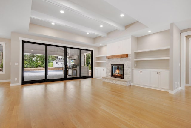 TBD Rosedale Ave N, Hanover, MN 55341 - unfurnished living room with healthy amount of natural light, light wood-style flooring, a fireplace, built in features, and beamed ceiling