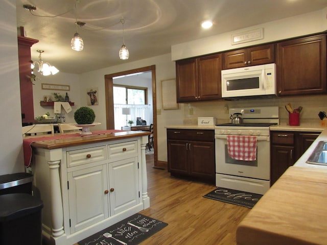 401 St Paul Ave, Fulda, MN 56131 - kitchen with white appliances, wood counters, light wood-type flooring, a chandelier, and dark brown cabinets