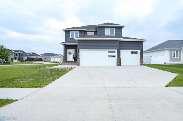 1326 Commander Dr W, West Fargo, ND 58078 - view of front of property with a garage, concrete driveway, stone siding, and a residential view