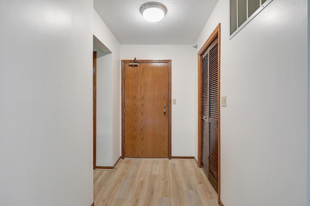 3801 98th St Unit 108, Bloomington, MN 55431 - corridor with light wood-style flooring and a textured ceiling