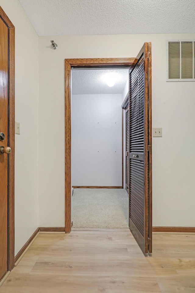 3801 98th St Unit 108, Bloomington, MN 55431 - hall featuring light wood-style floors and a textured ceiling
