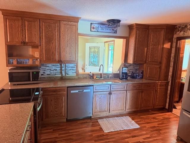 20430 Rhoda Ave, Ravenna Twp, MN 55089 - kitchen with appliances with stainless steel finishes, wood finished floors, tasteful backsplash, and brown cabinetry