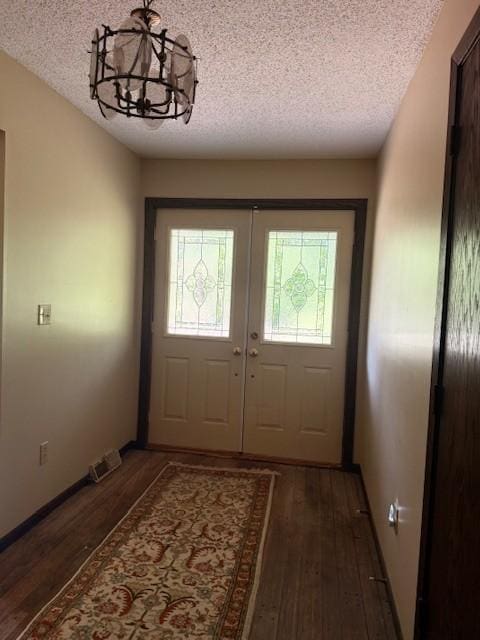 20430 Rhoda Ave, Ravenna Twp, MN 55089 - entryway featuring a textured ceiling, wood finished floors, a chandelier, and french doors