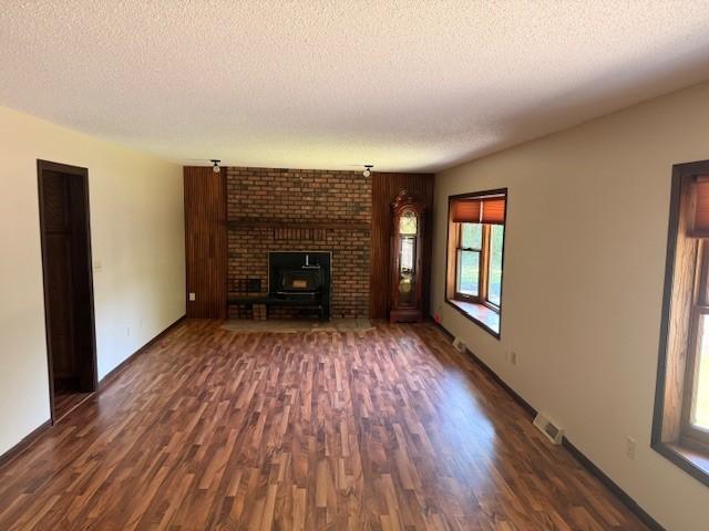 20430 Rhoda Ave, Ravenna Twp, MN 55089 - unfurnished living room featuring dark wood finished floors and a textured ceiling