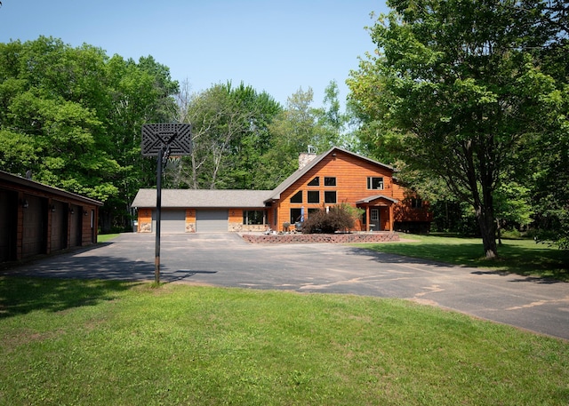 9777 Gruhlke Rd, Summit Twp, WI 54836 - view of front of house featuring a chimney, a front lawn, and view of wooded area