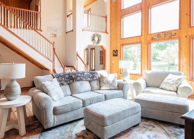 9777 Gruhlke Rd, Summit Twp, WI 54836 - living area featuring a high ceiling, stairway, and wood walls