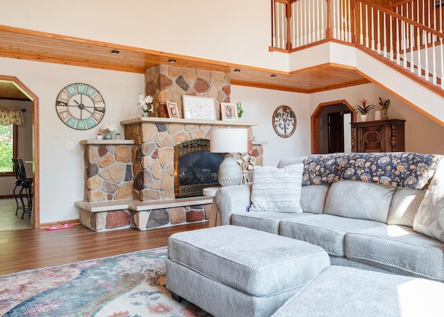 9777 Gruhlke Rd, Summit Twp, WI 54836 - living area featuring wood finished floors, a fireplace, stairs, and a high ceiling