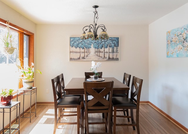 9777 Gruhlke Rd, Summit Twp, WI 54836 - dining area with wood finished floors and a chandelier