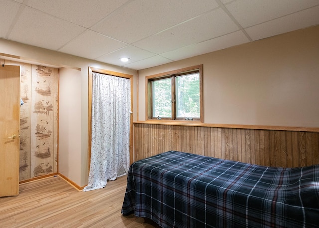 9777 Gruhlke Rd, Summit Twp, WI 54836 - bedroom with a paneled ceiling, light wood finished floors, wooden walls, and recessed lighting