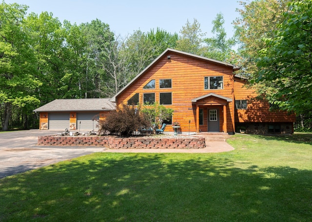 9777 Gruhlke Rd, Summit Twp, WI 54836 - rustic home featuring asphalt driveway, a front yard, and a garage