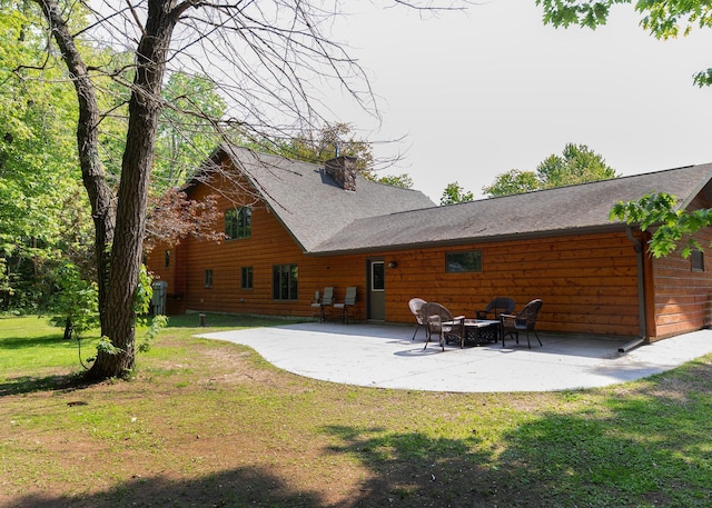 9777 Gruhlke Rd, Summit Twp, WI 54836 - back of property with a patio area, a lawn, and a shingled roof