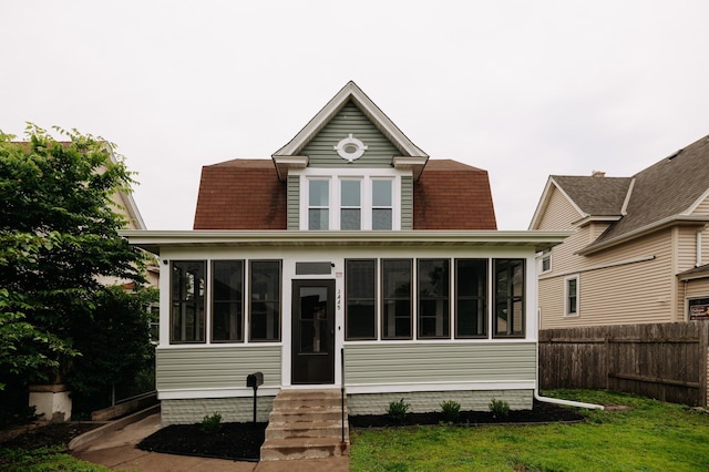 3445 4th Ave S, Minneapolis, MN 55408 - rear view of property with a sunroom, entry steps, and a shingled roof