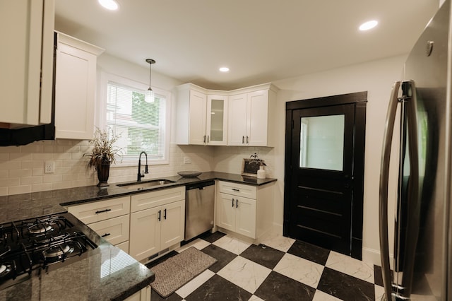 3445 4th Ave S, Minneapolis, MN 55408 - kitchen with appliances with stainless steel finishes, tasteful backsplash, recessed lighting, white cabinetry, and dark stone counters