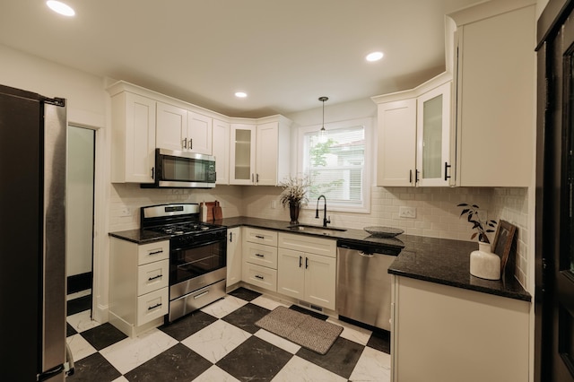 3445 4th Ave S, Minneapolis, MN 55408 - kitchen with stainless steel appliances, white cabinetry, decorative backsplash, recessed lighting, and glass insert cabinets