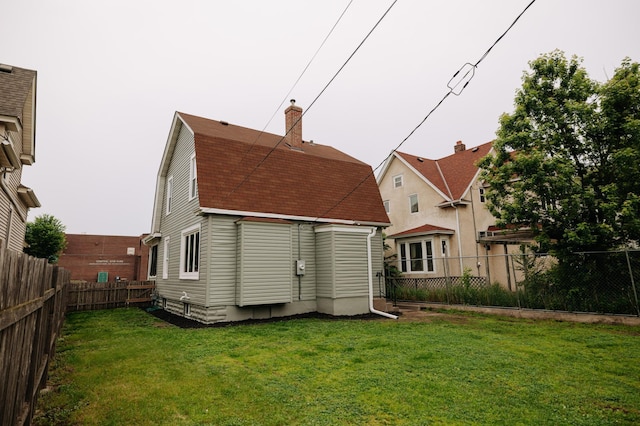 3445 4th Ave S, Minneapolis, MN 55408 - back of property featuring a gambrel roof, roof with shingles, a fenced backyard, and a chimney