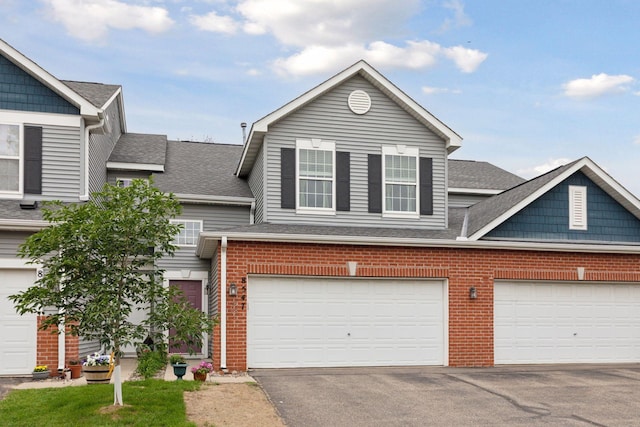 8547 Grove Cir, Shakopee, MN 55379 - view of front of property featuring brick siding, a shingled roof, and driveway