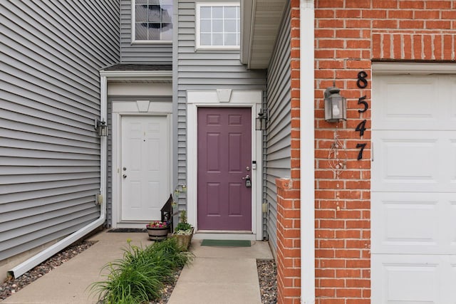 8547 Grove Cir, Shakopee, MN 55379 - view of exterior entry featuring a garage and brick siding