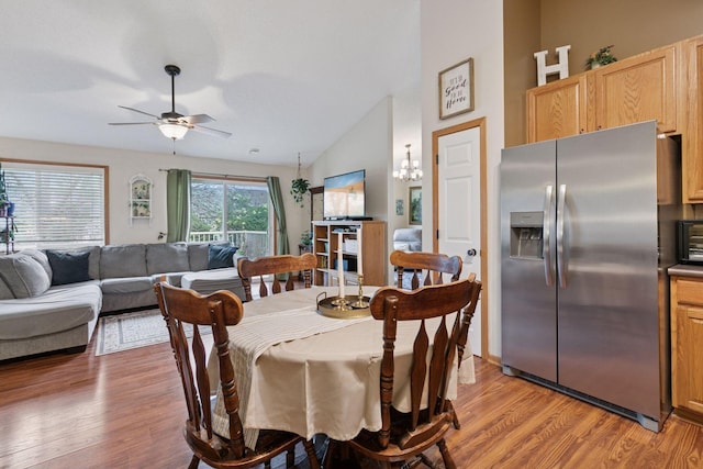 8547 Grove Cir, Shakopee, MN 55379 - dining area featuring a ceiling fan, light wood-style flooring, a chandelier, and lofted ceiling