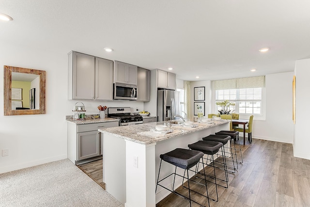 6730 Hinterland Trl S, Cottage Grove, MN 55016 - kitchen with stainless steel appliances, gray cabinets, a breakfast bar, and recessed lighting