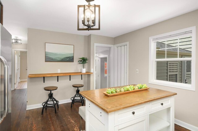333 3rd St NE, Osseo, MN 55369 - kitchen with stainless steel fridge with ice dispenser, white cabinetry, dark wood-style floors, and a chandelier